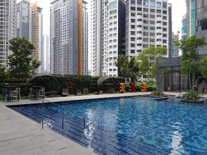 a large swimming pool in a city with tall buildings at Star KLCC by Arman in Kuala Lumpur