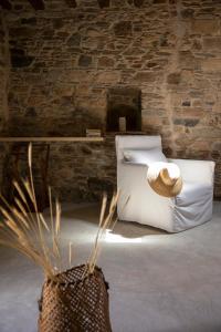 a bedroom with a bed with a straw hat on it at Onos Eco Living in Mési