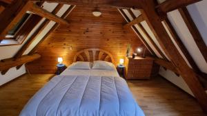 La Ferme de Wolphus في Zouafques: غرفة نوم بسرير كبير في العلية