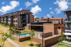 an image of an apartment complex with a swimming pool at Smart apartment 322 in Midrand