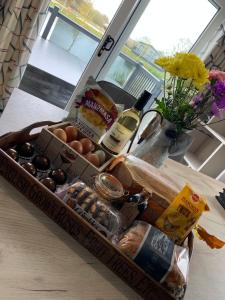 a box of eggs and wine on a table at Bay Tree Lodge: Lakeside lodge w/hot tub & cinema surround sound in Woodhall Spa