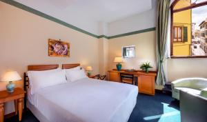 Postel nebo postele na pokoji v ubytování Hotel Botticelli