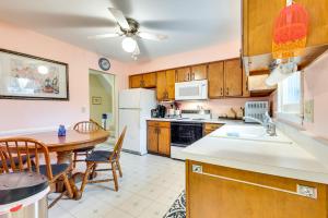 a kitchen with a table and a white refrigerator at Clear Lake Vacation Home Rental - Pet Friendly! in Clear Lake
