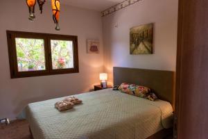 a bedroom with a bed and a window at Calypso Villa with Jacuzzi Pool & Sea View in Nerotriviá +92 photos