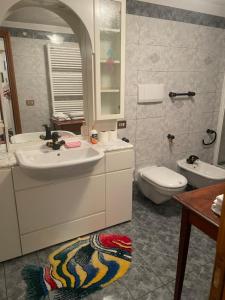 a bathroom with a sink and a toilet at Appartamento dolomiti in Auronzo di Cadore +8 photos