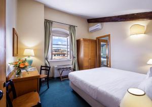 Postel nebo postele na pokoji v ubytování Hotel Botticelli