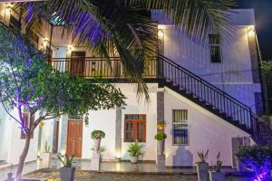 a house with a staircase on the side at night at Airport J Dream Resort in Dewamottawa