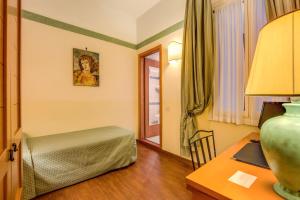 Postel nebo postele na pokoji v ubytování Hotel Botticelli