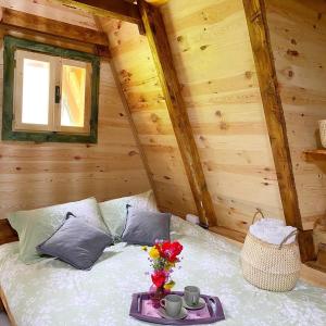a bedroom with a bed in a wooden cabin at Eco kutak 2 in Mojkovac
