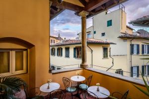 a balcony with tables and chairs in a building at Hotel Botticelli in Florence