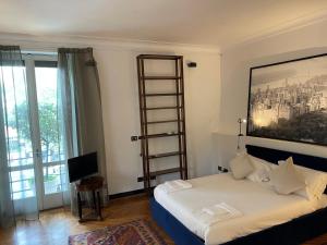 a bedroom with a bed with a picture on the wall at ELEGANT ROOMS PARIOLI in Rome