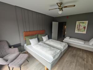 ein Schlafzimmer mit einem Bett und einem Stuhl in der Unterkunft Hotel Marina in Vedbæk