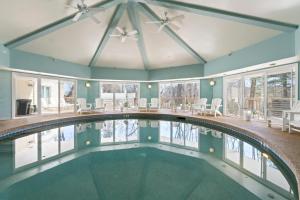 an indoor swimming pool in a house with a ceiling fan at The Grand Hotel in Ogunquit
