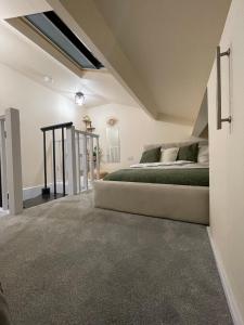 a bedroom with a bed in a attic at Unique Duplex Apartment FREE parking FREE Wi-Fi 6 minutes from Leeds city centre in Leeds