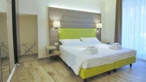 a bedroom with a large bed with a green headboard at Italianway - Affittacamere Brenna in Como