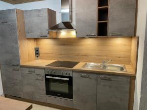 a kitchen with a sink and a stove at Sonnleitn 29 in Sonnenalpe Nassfeld