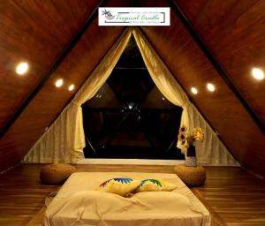 a bed in a tent with two pillows on it at Tropical Cradle @ River Dale in Kalyānpur