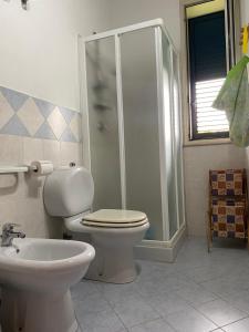 a bathroom with a shower and a toilet and a sink at Casa Gaia in Avola