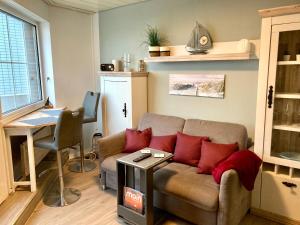 a living room with a couch and a table at Passat 11 in Wangerooge +7 photos