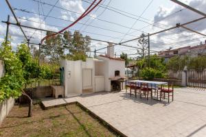een patio met een tafel en stoelen in de achtertuin bij Casa con giardino in Posada