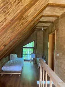 a attic room with a bed and a staircase at Cozy 3 bedroom mountain villa with scenic views in Novoberdo