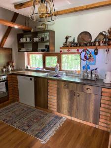 a kitchen with wooden cabinets and a counter top at Cozy 3 bedroom mountain villa with scenic views in Novoberdo