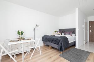 a bedroom with a bed and a table and chairs at Elegant Pet-Friendly Studio in Krakow by Renters in Krakow