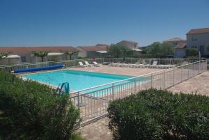 une piscine entourée d'une clôture métallique dans l'établissement Résidence A NUCIOLA Les pieds dans l'eau Cervione Hte CORSE, à Cervione