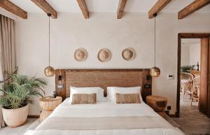 a bedroom with a large bed with two baskets on the wall at Le Sidi - A TLT Signature Hotel in El Alamein +53 photos