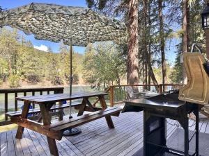 a picnic table and a grill on a deck at Jack's Cabin by NW Comfy Cabins in Leavenworth
