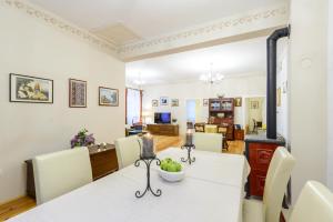 a dining room and living room with a table and chairs at Villa Balic in Gruda
