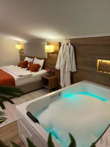 uma casa de banho com banheira num quarto com uma cama em White House Hotel em Trabzon