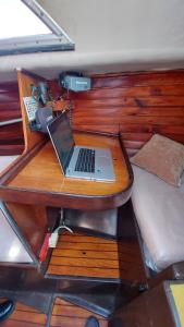 a desk with a laptop on it next to a bed at Boat Barcelona Yacht in Barcelona