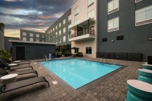 a swimming pool with lounge chairs next to a building at Hampton Inn New Orleans French Quarter Market Area in New Orleans