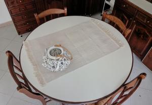 a white table with a table cloth on it at Il Giardino in Baunei