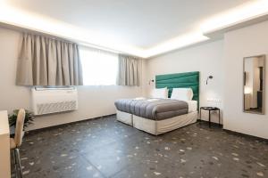 a hotel room with a bed and a window at City Life Athens Apartments in Athens