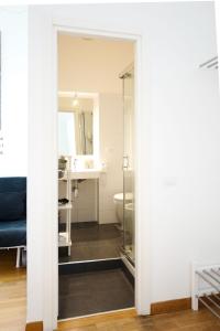 a bathroom with a toilet and a sink and a mirror at I'MC IoAMoCagliari in Cagliari +43 photos