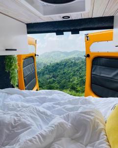 a bed in the back of a van with a view at BeeVan in Aguadilla