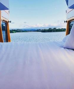 a bed on a boat on a body of water at BeeVan in Aguadilla