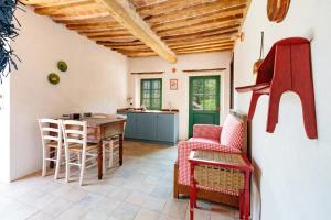 a kitchen and living room with a table and chairs at Tenuta Miranda in Cassinasco