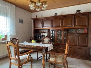 a dining room with a table and wooden cabinets at Berg I 