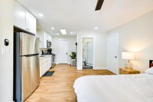 a white bedroom with a bed and a kitchen at Pet-Friendly San Diego Studio about 14 Mi to Downtown in San Diego +17 photos