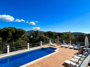 a swimming pool on a patio with a view of the mountains at Vivalidays Casa Ricardo in Sant Cebrià de Vallalta
