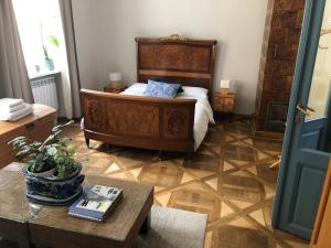a bedroom with a large bed and a table at Przemysl Old Town Style in Przemyśl