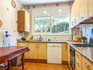 a kitchen with a sink and a window at Vivalidays Casa Ricardo in Sant Cebrià de Vallalta