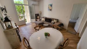 a living room with a table and a couch at Super Flat, Garden. Bnbrickeys in Monte Carlo