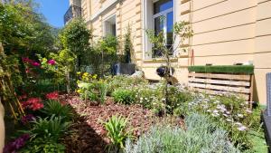 a garden in front of a house with flowers at Super Flat, Garden. Bnbrickeys in Monte Carlo