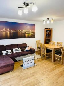 a living room with a couch and a table at Family Relax in the Seaside Town with Parking in Hastings