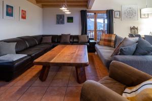 a living room with a couch and a coffee table at Ekseption - 7-room chalet + sauna 12/14 persons in Peisey-Nancroix