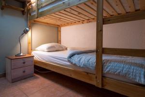 a bedroom with a wooden bunk bed and a lamp at Ekseption - 7-room chalet + sauna 12/14 persons in Peisey-Nancroix